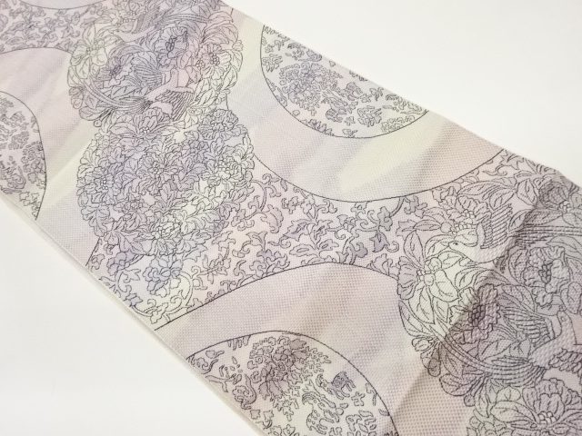 Nagoya obi woven with floral circle, animal, and floral arabesque patterns on a